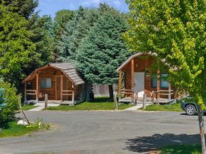 Riversong Retreat and Sagebrush Sanctuary cabins among evergreens