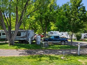 Side view of an RV site with a picnic table